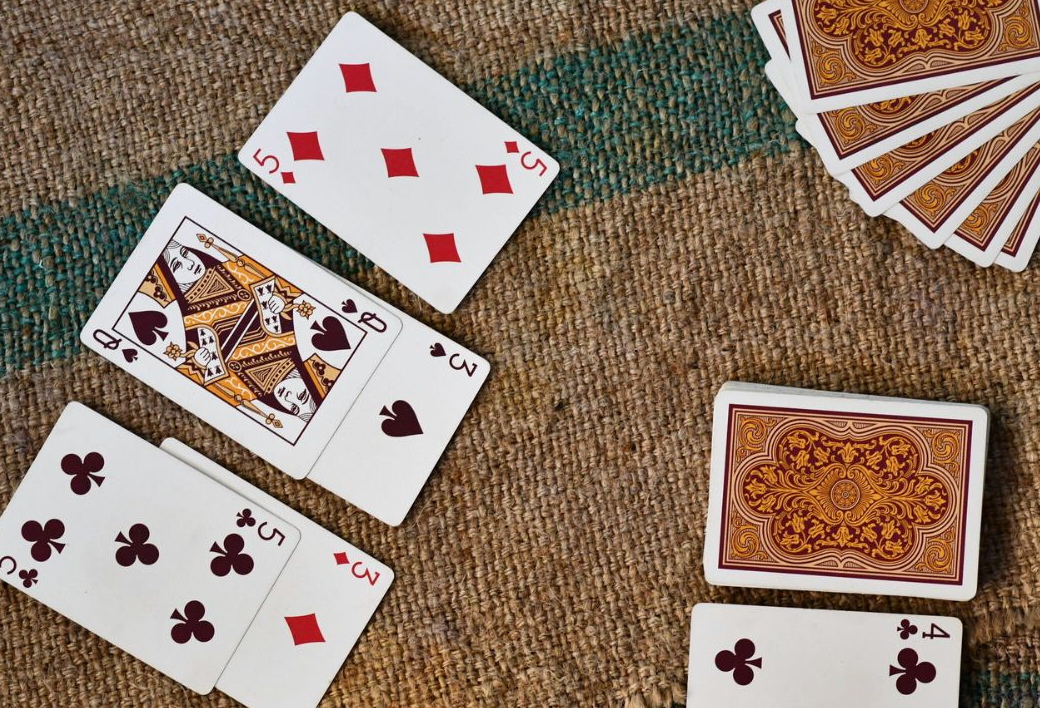Playing cards fanned beside a deck